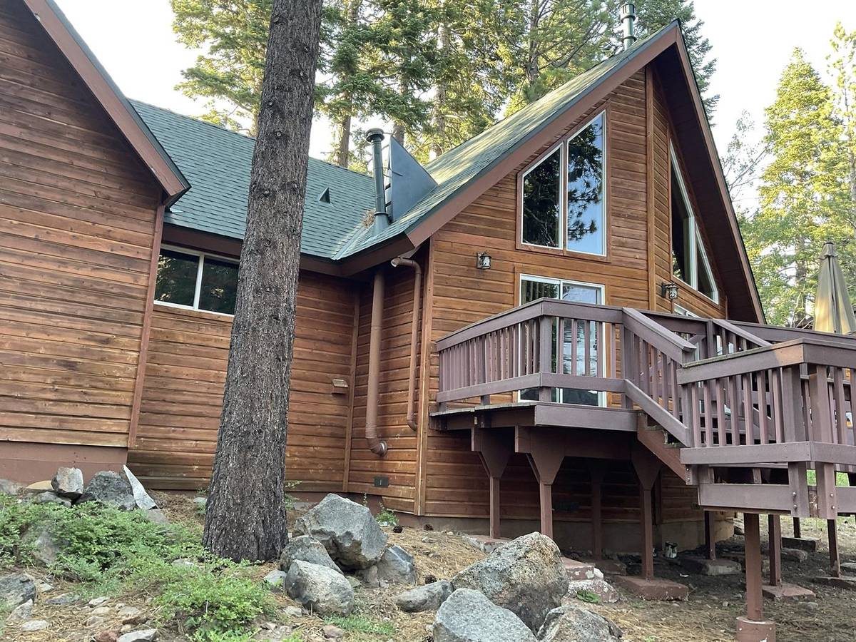 Wood-sided home with a deck in a rich cedar stain
